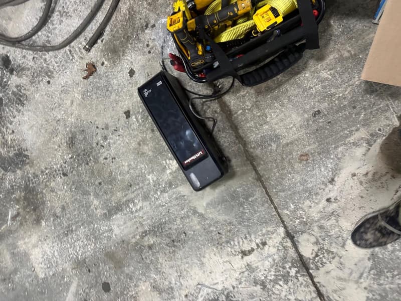LiftMaster garage door opener unit staged during service with technician tools nearby